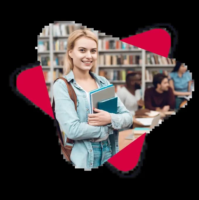 an ECCE student smiling in a library while holding some notebook and a book