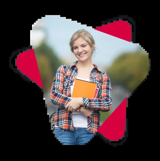 A TESOL student standing in the street and holding some red and yellow notebook