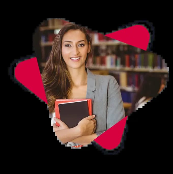 a ecce diploma course student standing in a library and holding some book with a smile