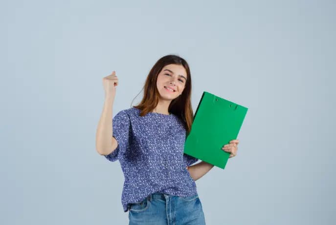 A teacher cheering up and holding a green board